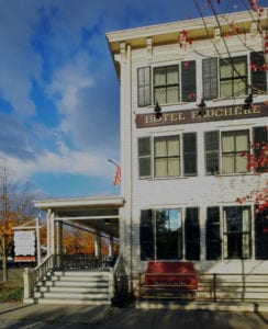 a white building with a red bench in front of it