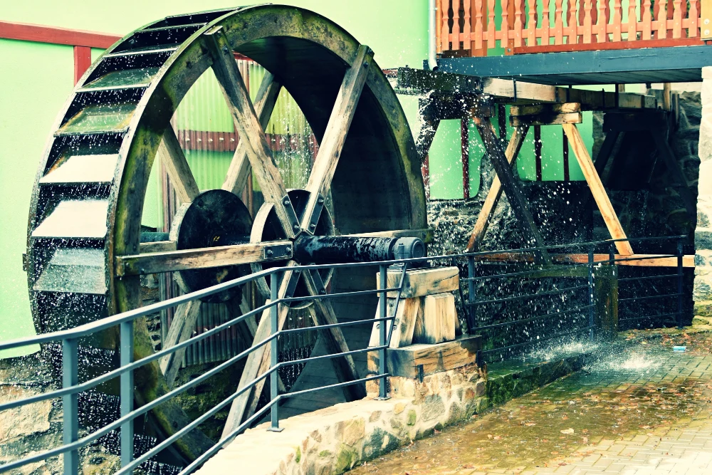 A turning wooden water wheel splashes water, a highlight of things to do in Milford PA.