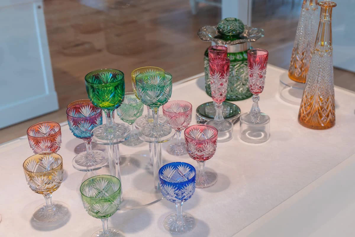 A collection of colorful and intricate cut-crystal glassware on display at the Hotel Fauchère.