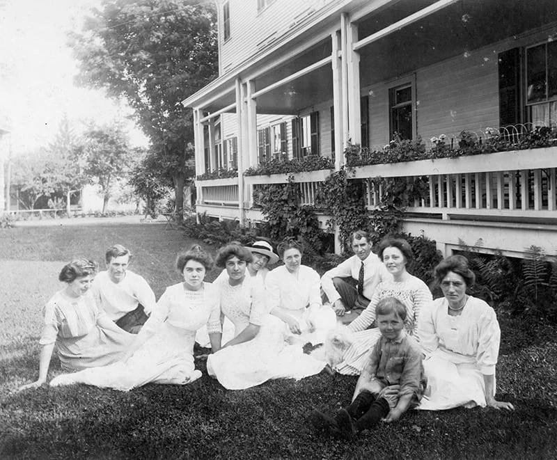 A group relaxes on the lawn of Hotel Fauchère, a landmark among historic places to stay in Milford, PA.