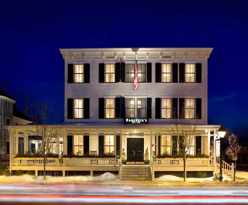 The glowing windows of Hotel Fauchère offer a warm welcome for those seeking places to stay in Milford, PA.