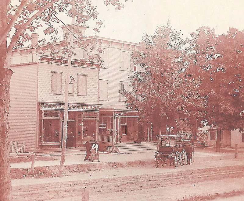 A vintage sepia photograph shows a horse-drawn carriage outside Hotel Fauchère in the Milford historic district.