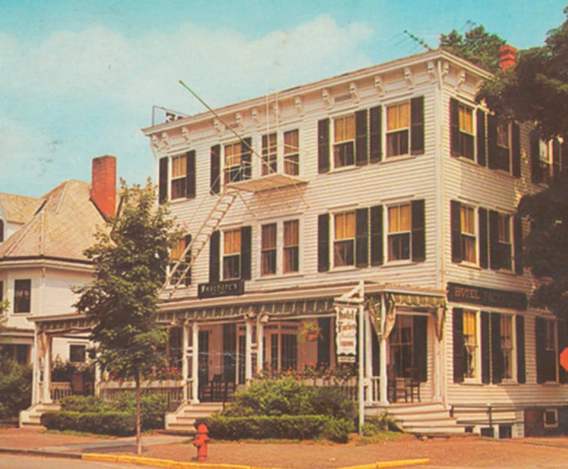 A vintage view of the historic Hotel Fauchère featuring classic white siding and black shutters in Milford, PA.