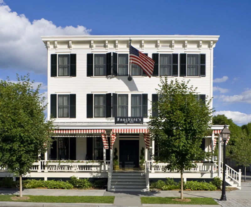 The historic white facade of Hotel Fauchère stands as a landmark in the Milford historic district.