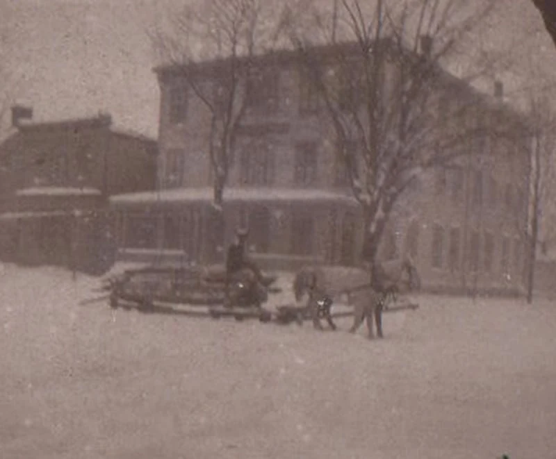 A horse-drawn sleigh travels through the snow in front of the historic Hotel Fauchère in Milford, Pennsylvania.