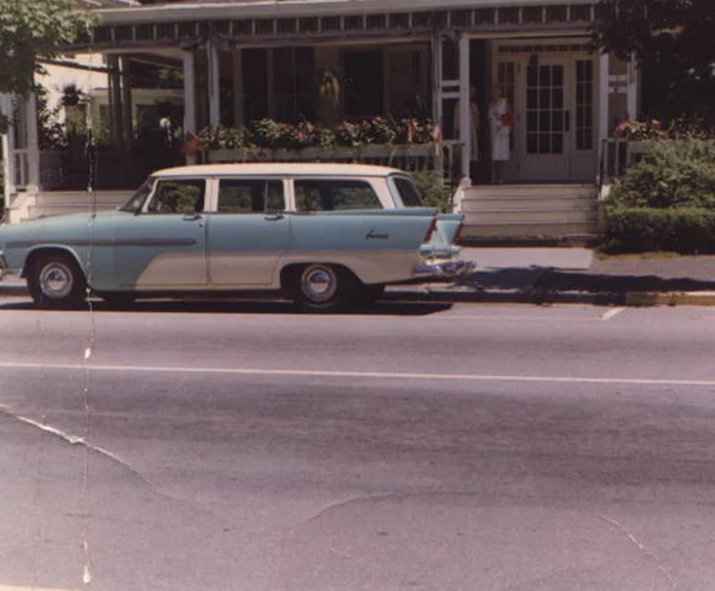 A classic station wagon parked in front of the porch at Hotel Fauchère in the Milford historic district.